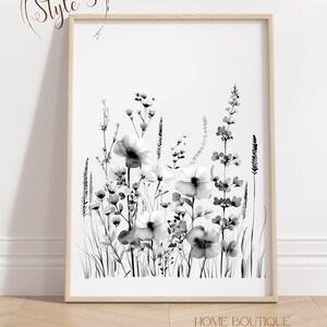 May include: Black and white watercolor print of a bouquet of wildflowers in a simple wooden frame. The print features a variety of flowers and grasses, including daisies, poppies, and ferns. The print is perfect for adding a touch of nature to any room.