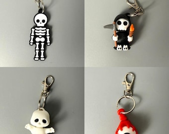Leuke Halloween sleutelhangerset in een geschenkverpakking met griezelige accessoires, zoals een rugzakhanger, ritssluiting en taslabel in gothic-stijl, perfect als herfstfeestcadeautje.