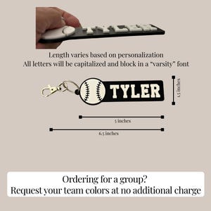 May include: A black and white keychain featuring a baseball graphic and the name TYLER in block varsity lettering. The keychain measures 1.5 inches in height and 5 inches in length, with a total length of 6.5 inches including the metal lobster clasp.