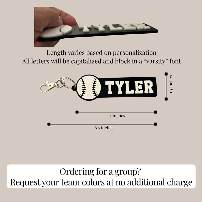 May include: A black and white keychain featuring a baseball graphic and the name TYLER in block varsity lettering. The keychain measures 1.5 inches in height and 5 inches in length, with a total length of 6.5 inches including the metal lobster clasp.