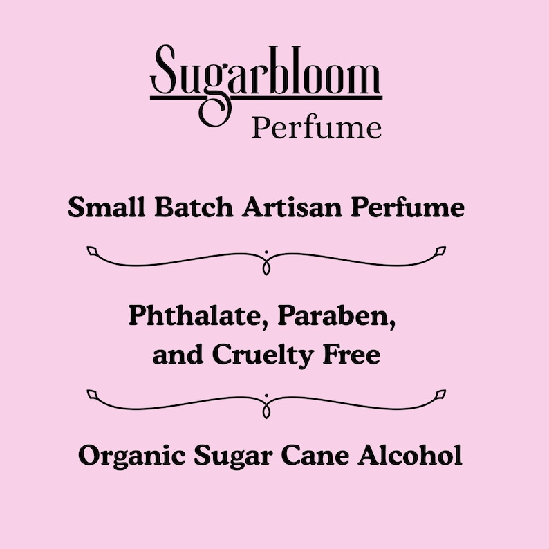 May include: A pink background with the text "Sugarbloom Perfume" in a decorative font. Below, it reads "Small Batch Artisan Perfume," followed by "Phthalate, Paraben, and Cruelty Free," and "Organic Sugar Cane Alcohol."