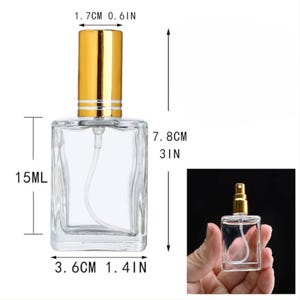 May include: A clear glass perfume bottle with a gold-colored cap. The bottle is rectangular, measuring 3 inches tall and 1.4 inches wide. It has a capacity of 15 ml. The cap is cylindrical, 0.6 inches in diameter.