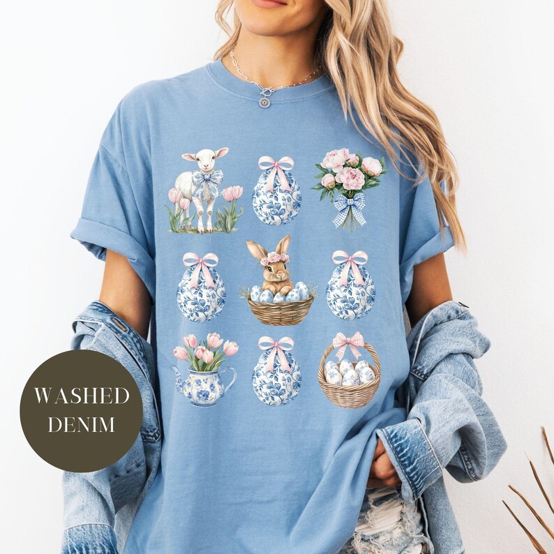 May include: A light blue t-shirt with a graphic design of Easter eggs, a bunny, a lamb, and flowers. The text "WASHED DENIM" is on the left side of the shirt.