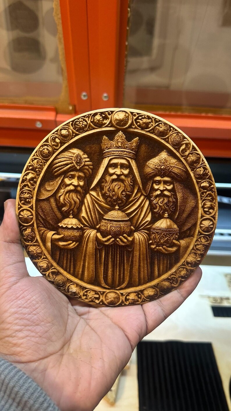 May include: A round wooden plaque with a detailed carving of the three wise men. The men are depicted in traditional robes and holding gifts. The plaque is surrounded by a decorative border.