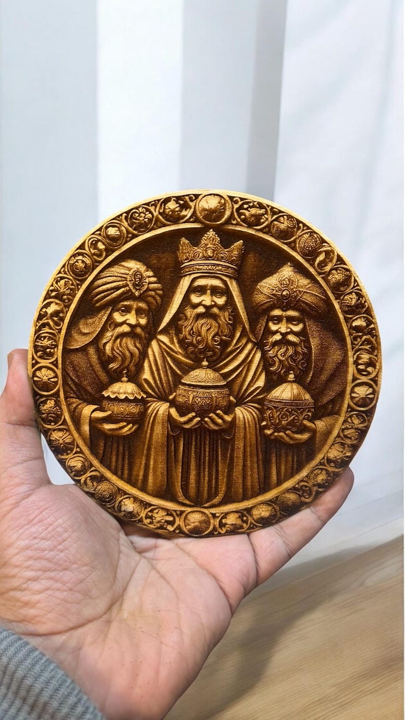 May include: A round wooden plaque with a carved image of the three wise men. The men are depicted in ornate robes and holding gifts. The plaque is surrounded by a decorative border.