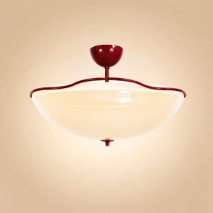May include: A ceiling light fixture with a red finish and a large, off-white glass bowl. The fixture has a decorative, wavy red trim around the edge of the bowl. The light is suspended from a red canopy.