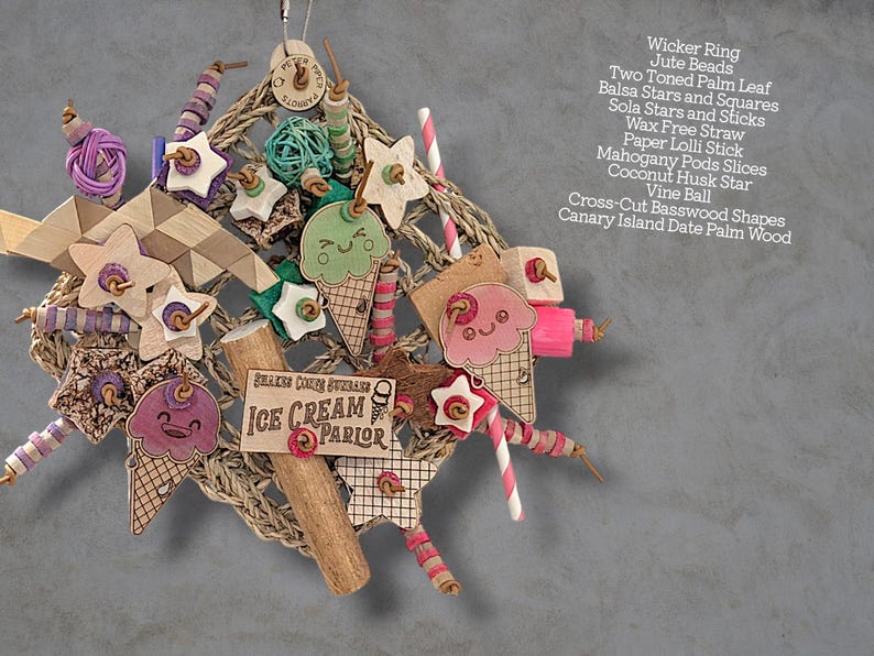 May include: A bird toy featuring a wicker ring base adorned with jute beads, two-toned palm leaf, balsa stars and squares, sola stars and sticks, wax-free straw, paper lolli sticks, mahogany pod slices, a coconut husk star, vine ball, and basswood.