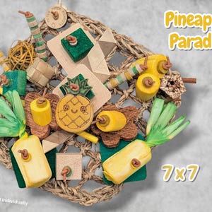 May include: A Pineapple Paradise bird toy set featuring a woven seagrass mat, wooden pineapple shapes, green paper shred, yellow wooden cylinders, and textured blocks. The set includes various natural materials and measures 7x7 inches.