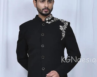 May include: A black long-sleeved kurta with a mandarin collar and silver embellishments on the shoulder. The kurta is paired with cream-colored pants.