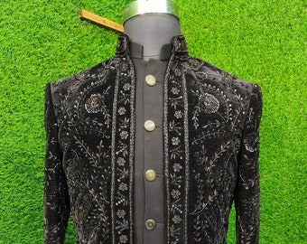 May include: A black velvet long-sleeved jacket with intricate silver embroidery. The jacket has a mandarin collar and a button closure. The jacket is on a mannequin against a green background. KGNdesigner is printed on the bottom right corner of the image.