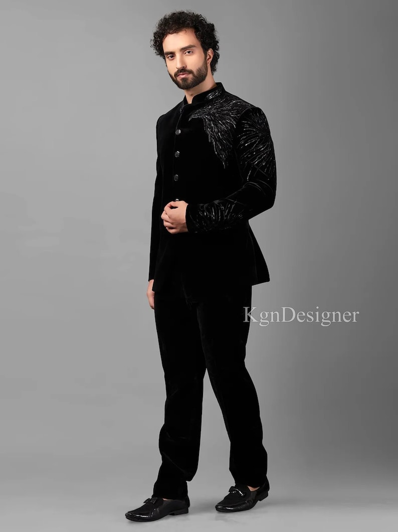 May include: A black velvet suit with a mandarin collar and a decorative design on the jacket. The suit is tailored and has a slim fit.