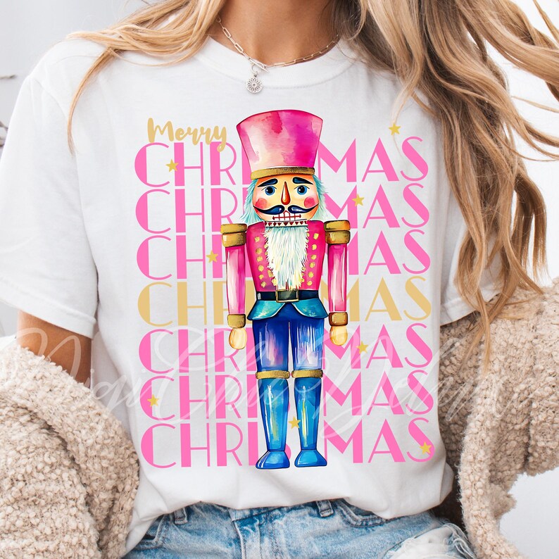 Hand-painted watercolor nutcracker soldier Christmas PNG design in vibrant pink, gold, and blue with festive stars and layered “Merry Christmas” lettering. Perfect for holiday shirts, Christmas party outfits, Nutcracker ballet gifts, winter home décor, festive wall art, seasonal apparel, cozy holiday decorations, and Christmas gift ideas for women and kids.