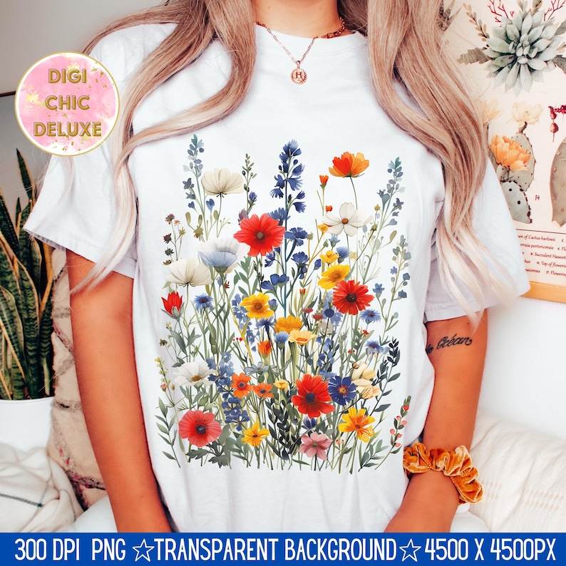 May include: A white t-shirt with a colorful floral print featuring red, yellow, blue, and white flowers. The flowers are arranged in a bouquet-like design.