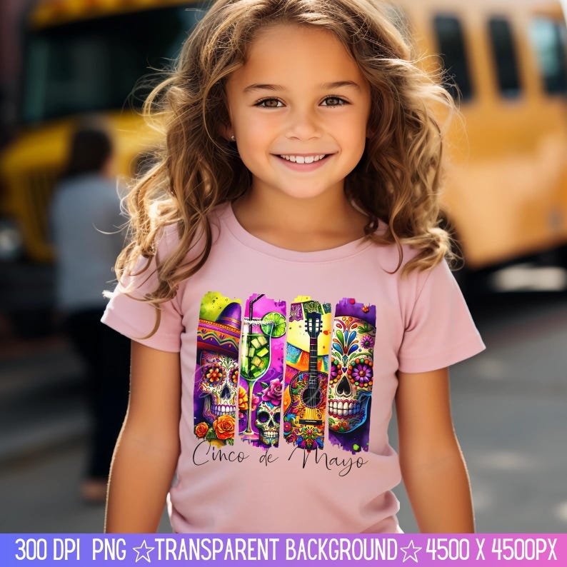 May include: A young girl wearing a pink t-shirt with a colorful graphic design featuring a guitar, a margarita glass, and three sugar skulls. The graphic also includes the text "Cinco de Mayo".