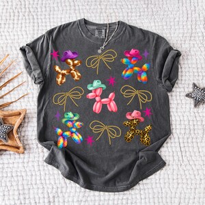 High-quality PNG design featuring cute Western balloon dogs wearing colorful cowboy hats in cow print, pink, tie-dye, and leopard patterns, surrounded by rope bows and retro stars; perfect for trendy coastal cowgirl T-shirts, rodeo shirts, Nashville bachelorette party outfits, girls trip apparel, country concert looks, western bachelorette decor, boho cowgirl gifts, summer rodeo outfits, and western fashion. 300 DPI transparent background for sublimation, DTF and DTG printing and craft projects.