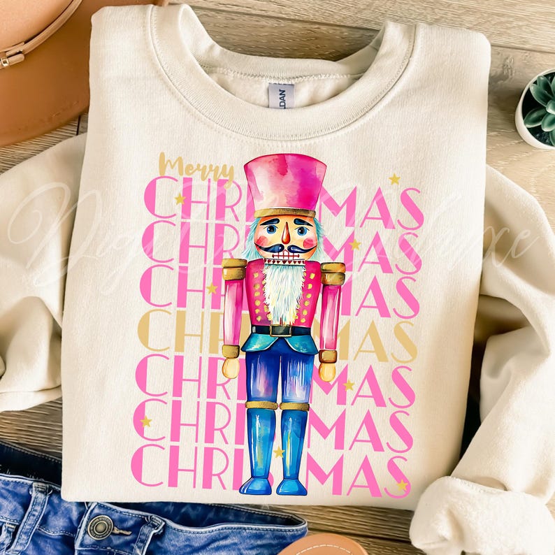 Hand-painted watercolor nutcracker soldier Christmas PNG design in vibrant pink, gold, and blue with festive stars and layered “Merry Christmas” lettering. Perfect for holiday shirts, Christmas party outfits, Nutcracker ballet gifts, winter home décor, festive wall art, seasonal apparel, cozy holiday decorations, and Christmas gift ideas for women and kids.