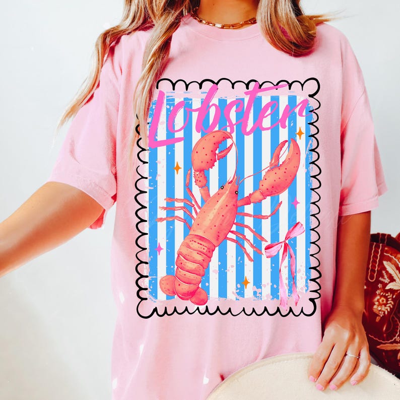 Bold watercolor lobster design with pink bow on nautical blue and white stripes — perfect for coastal cowgirl aesthetic, seafood lovers, Maine lobster festival gifts, retro summer beach vibes, ocean-themed apparel, and girly cottagecore fans. Trendy crustacean print for quirky fashion, East Coast preppy style, Y2K nautical chic, or seaside travel souvenir. Great for lobster parties, boating outfits, or colorful graphic tees with a fun foodie twist.