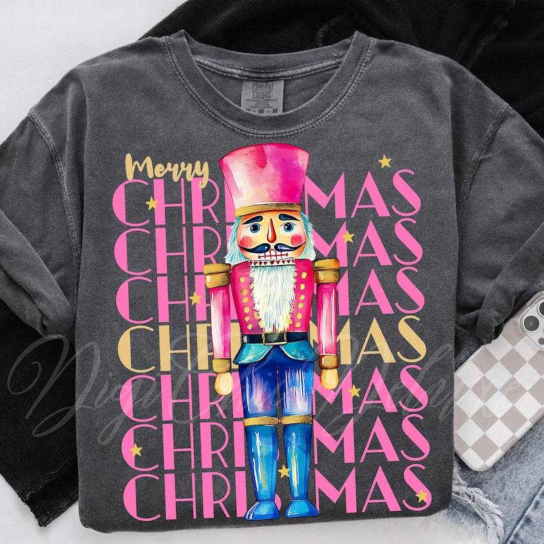 Hand-painted watercolor nutcracker soldier Christmas PNG design in vibrant pink, gold, and blue with festive stars and layered “Merry Christmas” lettering. Perfect for holiday shirts, Christmas party outfits, Nutcracker ballet gifts, winter home décor, festive wall art, seasonal apparel, cozy holiday decorations, and Christmas gift ideas for women and kids.