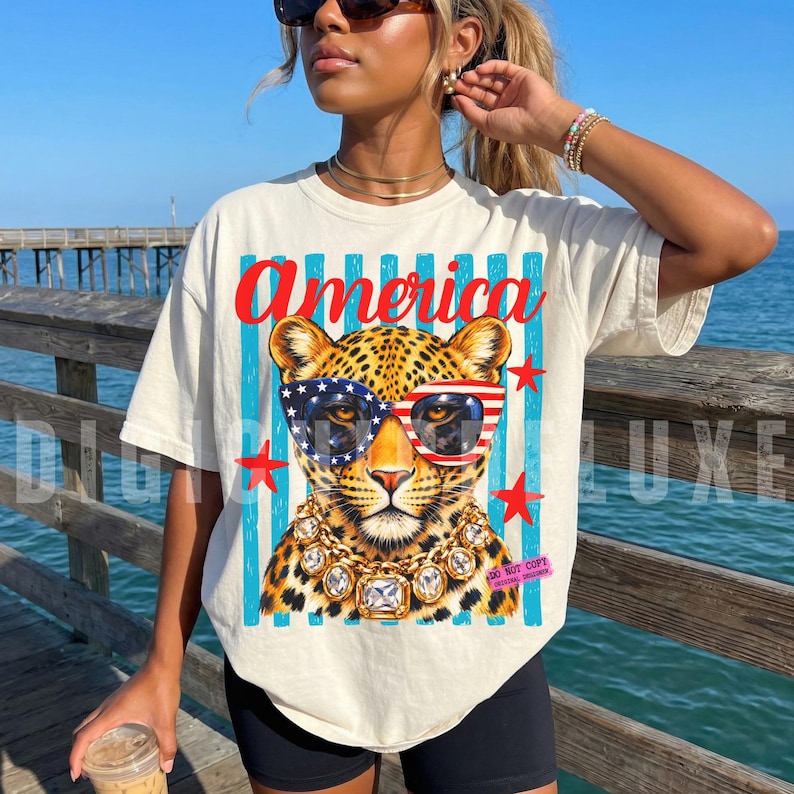 Patriotic leopard PNG design featuring glamorous leopard wearing American flag sunglasses and chunky gold jewelry on retro blue striped background. Trendy USA coquette animal graphic perfect for 4th of July shirts, patriotic apparel, summer vacation tees, western glam fashion, Independence Day party outfit, leopard lover gift, sublimation PNG, DTF transfer, print on demand design, tumbler wrap, mug design, wall art printable, boutique graphic tee, trendy Americana aesthetic clipart.