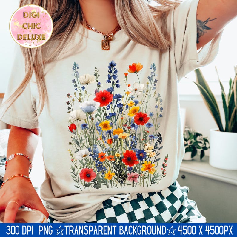 May include: A white t-shirt with a colorful floral print featuring red, yellow, blue, and white flowers. The flowers are arranged in a bouquet-like design.