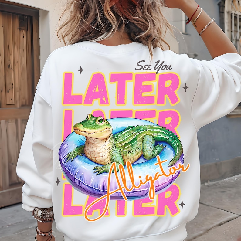 Funny “See You Later Alligator” t-shirt PNG design with cute hand drawn watercolor alligator lounging in a pool float, retro pink and yellow text, summer vacation vibes, beach day shirt, animal humor tee, playful wildlife graphic tee, tropical novelty shirt, kids or adult funny alligator shirt, swamp theme apparel, southern charm gifts, Florida summer shirts, best-selling lake trip shirts, popular quirky animal t-shirt design PNG.