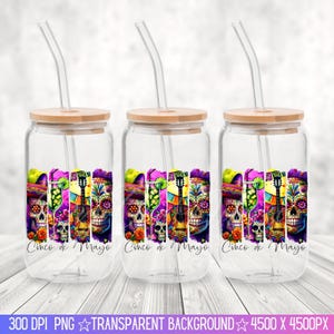 May include: Three clear glass tumblers with bamboo lids and straws. Each tumbler features a colorful design with a sugar skull, flowers, and a guitar. The text "Cinco de Mayo" is printed on each tumbler.
