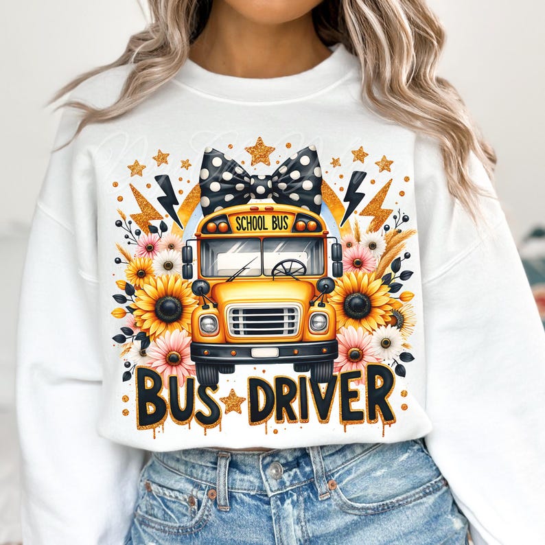 May include: White sweatshirt with a yellow school bus graphic, black and white polka dot bow, and the text "Bus Driver" in gold glitter. The bus has the words "School Bus" on the front.