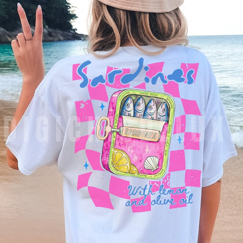 Trendy sardines shirt design featuring a pink illustrated sardine tin can with fish, lemon slices, shell detail, blue lettering, and hot pink checkerboard background. Cute Mediterranean foodie graphic perfect for coastal Europe vacations, European summer outfits design, fish market aesthetic, seafood lover gifts, retro vacation shirts design, beach trip apparel design, coastal boutique fashion, and trendy graphic shirt design for women, girls trips, and summer travel. For sublimation and DTF.