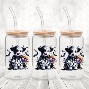 Adorable baby Highland cow in a black skull cape and spooky dress, holding a colorful fall bouquet with a skull plush. This cute Halloween cow PNG design is perfect for sublimation, fall clipart, kids Halloween shirt designs, printable wall art, spooky cute decor, cow lover gifts, and gothic autumn apparel. Great for tees, sweaters, mugs, and farmhouse Halloween crafts.
