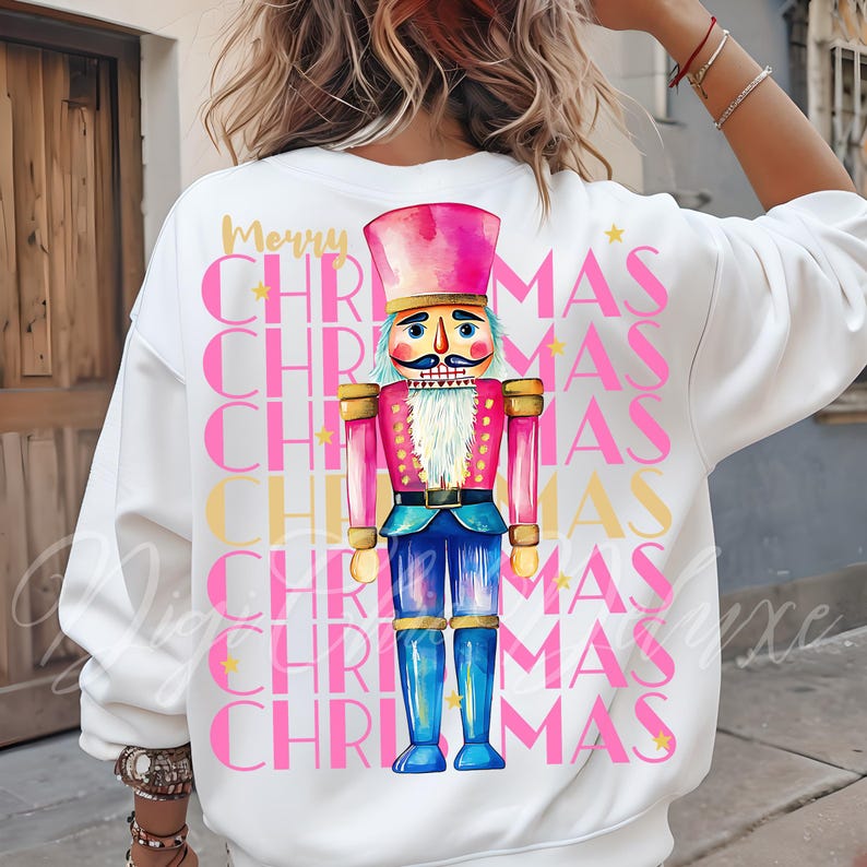 Hand-painted watercolor nutcracker soldier Christmas PNG design in vibrant pink, gold, and blue with festive stars and layered “Merry Christmas” lettering. Perfect for holiday shirts, Christmas party outfits, Nutcracker ballet gifts, winter home décor, festive wall art, seasonal apparel, cozy holiday decorations, and Christmas gift ideas for women and kids.