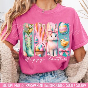 May include: A pink t-shirt with a graphic design of a bunny, a boot, carrots, and Easter eggs. The text "Happy Easter" is printed on the shirt.