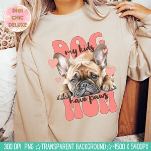 May include: A beige sweatshirt with a pink graphic design featuring a French bulldog puppy with the text "Dog my kids have paws Mom".