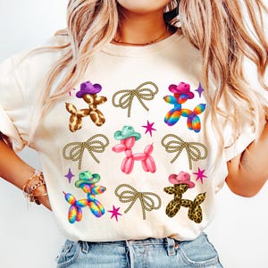 High-quality PNG design featuring cute Western balloon dogs wearing colorful cowboy hats in cow print, pink, tie-dye, and leopard patterns, surrounded by rope bows and retro stars; perfect for trendy coastal cowgirl T-shirts, rodeo shirts, Nashville bachelorette party outfits, girls trip apparel, country concert looks, western bachelorette decor, boho cowgirl gifts, summer rodeo outfits, and western fashion. 300 DPI transparent background for sublimation, DTF and DTG printing and craft projects.