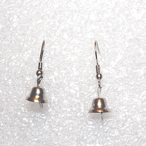 May include: A pair of silver bell dangle earrings. The bells are round and have a smooth, shiny finish.