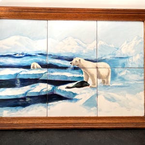 May include: A wooden tray with a tile inlay depicting a polar bear and a seal on a snowy landscape. The tiles are arranged in a grid pattern and the tray has a dark brown finish.