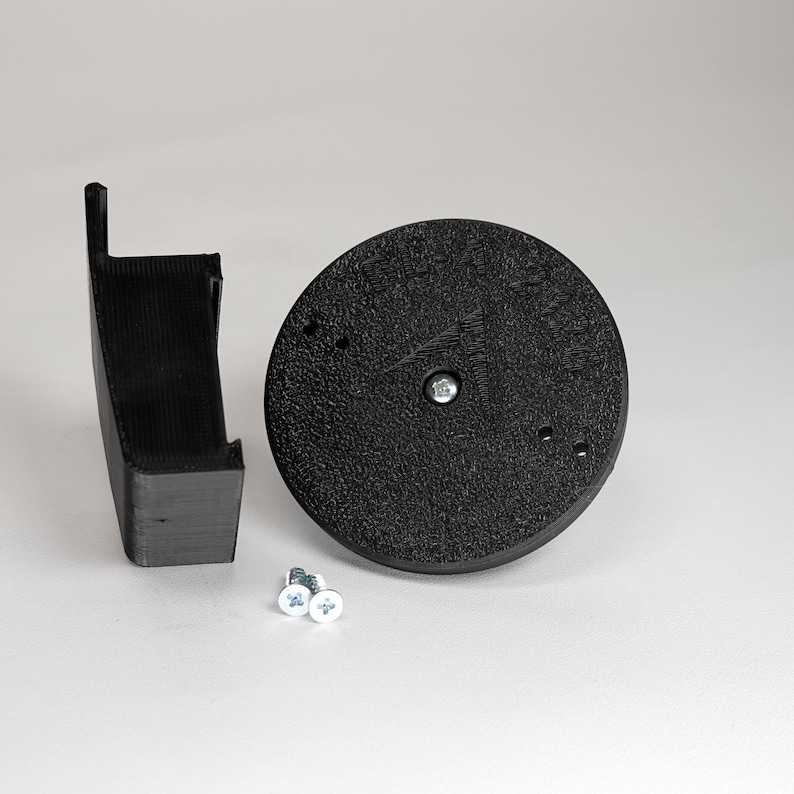 3D-printed traditional vinyl siding clip and circular mounting base for a Blink camera, include screws.