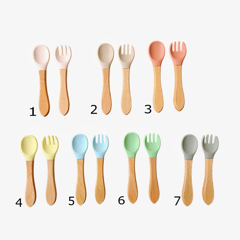 May include: Set of seven silicone and wooden baby spoons and forks in various colors, including pink, beige, peach, yellow, light blue, green, and gray. Each set includes a spoon and fork.