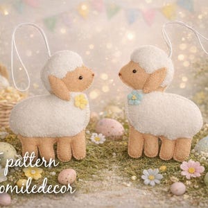 May include: Two handmade white felt lamb ornaments with tan ears and legs, each adorned with a small flower. They stand on a bed of green moss, surrounded by Easter eggs and flowers. A basket and bunny are in the background.