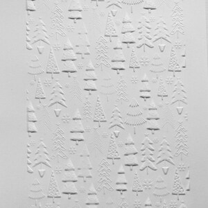 May include: White embossed paper with a repeating pattern of stylised Christmas trees. The trees are arranged in rows and are of varying sizes.