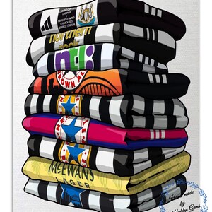 May include: A stack of folded sports team scarves, featuring black and white stripes, and various team logos and text. The scarves are in different colors, including black, white, orange, blue, and yellow. The text includes "Newcastle United" and "MCEWAN'S LAGER".
