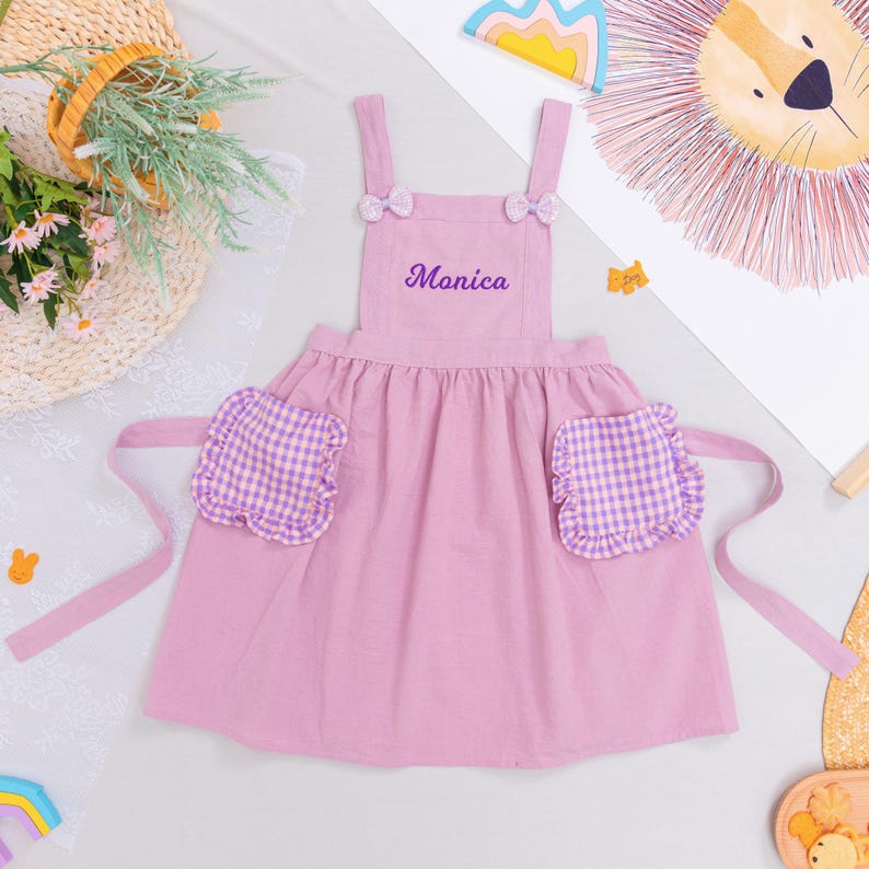 Embroidered Name Kids Apron, Cooking Apron with Sequin Bows, Adjustable Straps & Gingham Pockets Purple - Small (2-6)