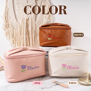 May include: Three cosmetic bags with embroidered roses and names. The bags are brown, pink, and white. The text on the bags reads "Bonnie", "Elaine", and "Olivia".