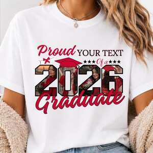 May include: White t-shirt with a graduation design. The design includes the words "Proud Graduate 2026" in red script, a graduation cap, and space for custom text. The shirt features photos of graduates.