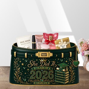 May include: A dark green cosmetic bag with gold accents, filled with beauty products. The bag features the text "She Did It, Class of 2026, Graduate" and a graduation cap design. Includes a face mask, perfume, and a gift box.