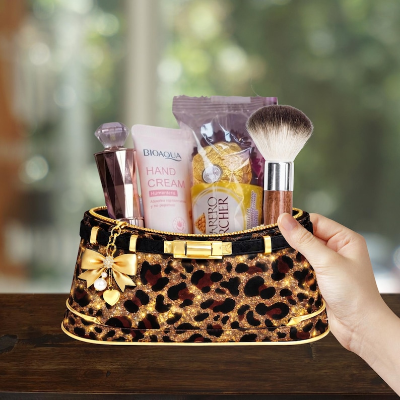 May include: A leopard print cosmetic bag filled with beauty products, including a perfume bottle, hand cream, a makeup brush, and wrapped chocolates. The bag has a gold zipper and bow detail.
