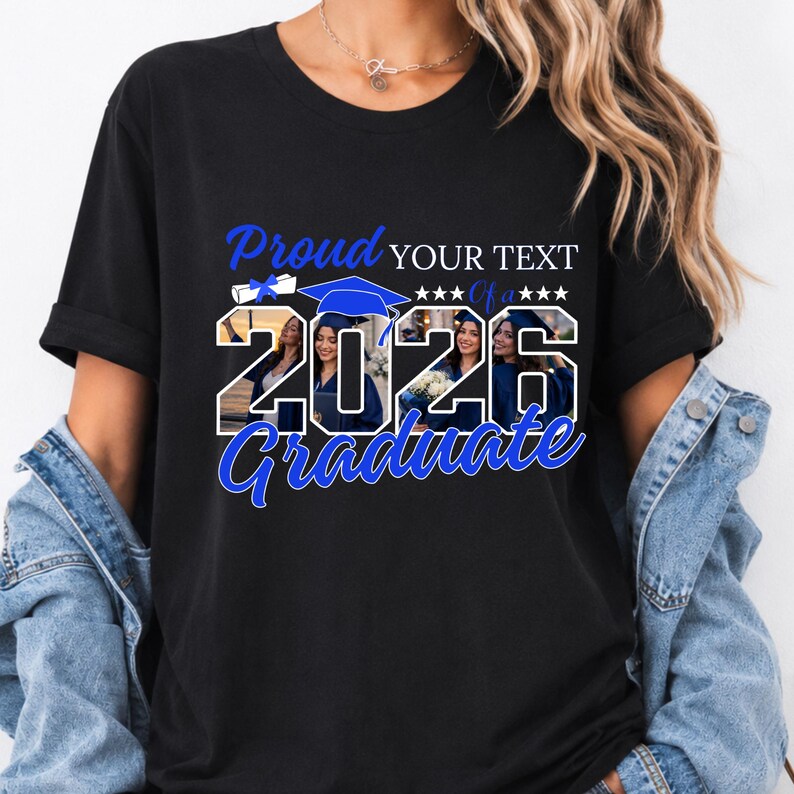 May include: Black t-shirt with a graduation theme. The design includes the words "Proud" and "Graduate" in blue script, along with the year "2026" and space for custom text. The shirt features images of graduates.