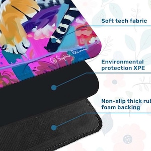 May include: A colorful mousepad with a vibrant abstract design featuring pink, blue, and yellow hues. The mousepad has a soft tech fabric surface, environmental protection XPE, and a non-slip thick rubber foam backing. The artist's signature, "@Sophie Clima," is visible.
