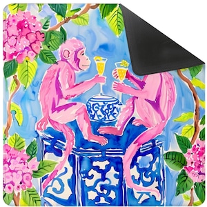May include: A vibrant illustration featuring two pink monkeys raising glasses. They are positioned on a blue and white patterned table, with pink flowers and green foliage around them. The background is a light blue, creating a cheerful, artistic scene.