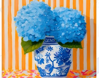 May include: An oil painting on a square canvas depicting two large, vibrant blue hydrangea blooms in a white and blue patterned ceramic vase. The background features vertical orange and white stripes, while the base has a pink and orange pattern.