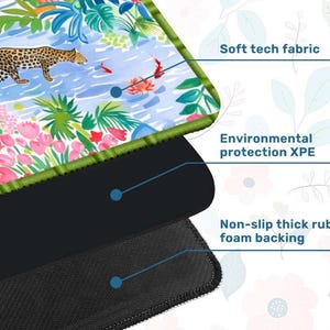 May include: Mouse mat with a vibrant jungle design, including a leopard, flowers, and water elements. It features a soft tech fabric surface, environmental protection XPE, and a non-slip thick rubber foam base.